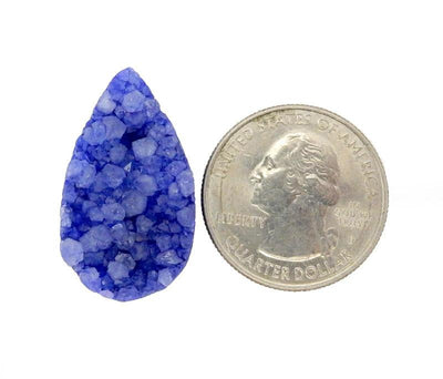purple tear drop druzy drilled bead next to a quarter for size reference