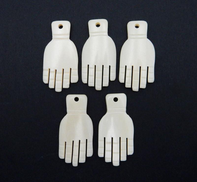 5 Fancy White Carved Bone Hand Top Drilled Beads on black background