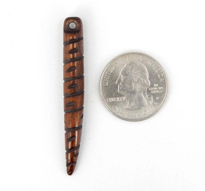 1 Bone Spike Pendant in Dark Brown with a Top Drilled Bead next to a quarter for size reference 