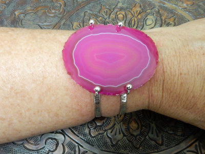 Pink Agate Slice on Electroplated 24k Gold Adjustable Bracelet on a wrist.