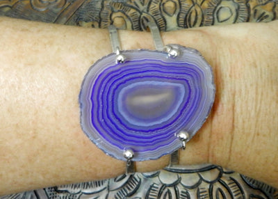 Purple Agate Slice with Adjustable Bracelet in silver on a wrist.