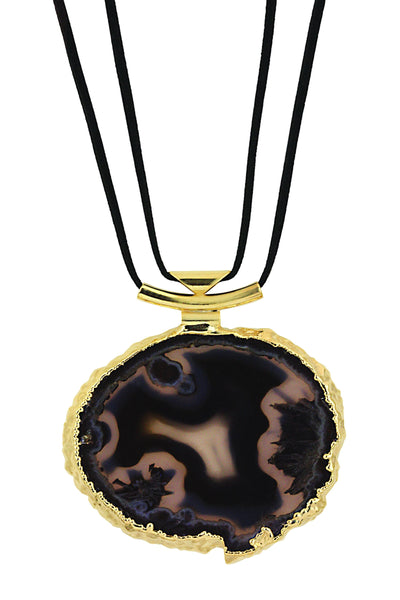 An agate necklace with black leather cord and gold bail with a white background.