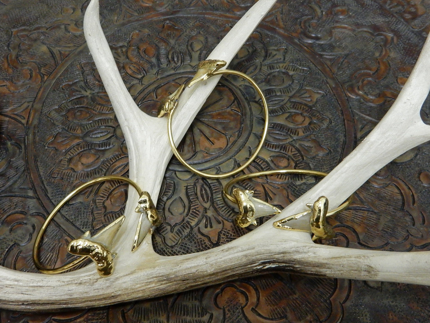 3 Double Light Shark Tooth edged in 24K Gold on Adjustable Cuff Bracelets on Brown Background.