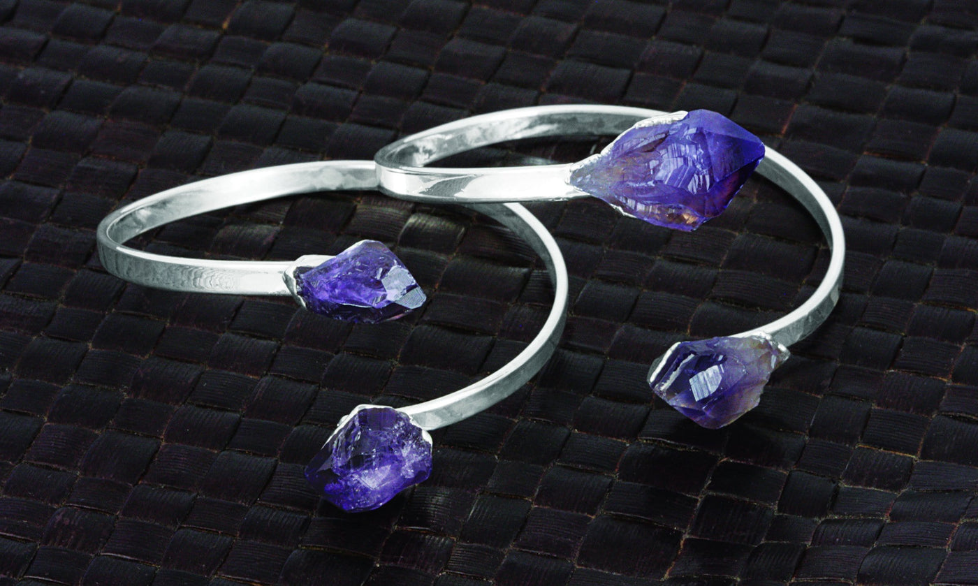 Two silver plated amethyst cuff bracelets with a point on each end and they are adjustable.