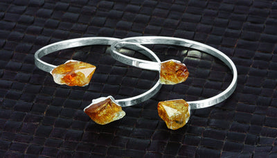 two citrine silver plated bracelets with a point on each end and they are adjustable.