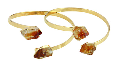 two gold plated citrine bracelets on a white background.