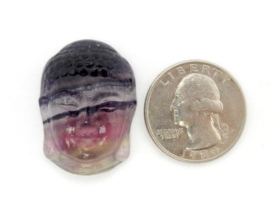 Buddha Cabochon Fluorite Buddah Head next to a quarter