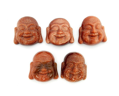 5 Goldstone Buddha Head Cabochons on white background