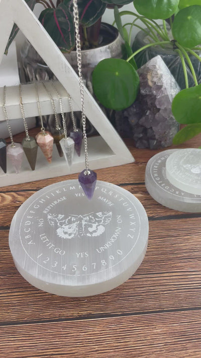 video of selenite moth pendulum board engraved charging plate in use with pendulum 