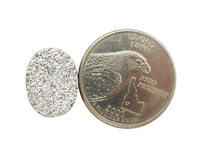 Platinum Oval Shaped Druzy Cabochon next to a quarter for size reference