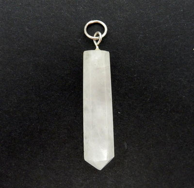 a single Calcite Crystal Point Pendant with Silver tone Bail on a black background