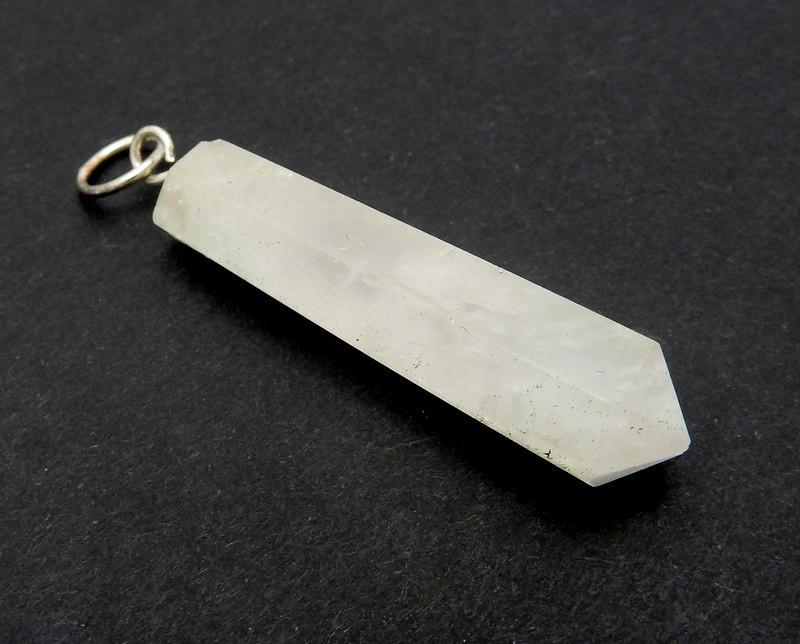 close up side angle of Calcite Crystal Point Pendant with Silver tone Bail on a black background