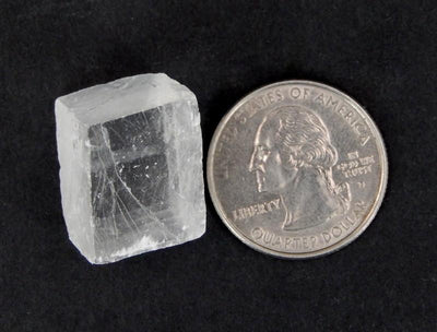 Petite Calcite Cube next to quarter for size comparison
