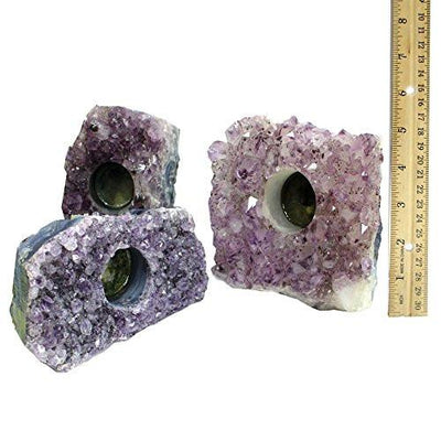 Picture of 3 amethyst candle holders, next to a ruler 