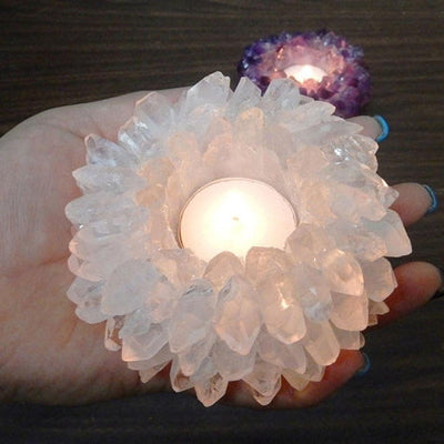 crystal quartz point candle holder with a candle lit in it