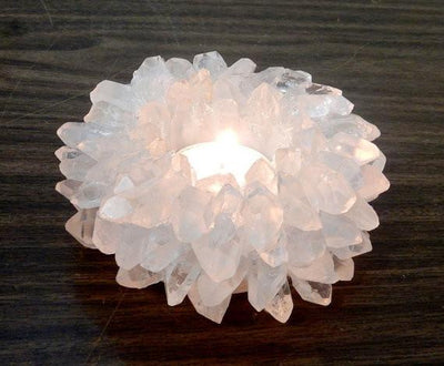 crystal quartz point candle holder with a candle lit in it