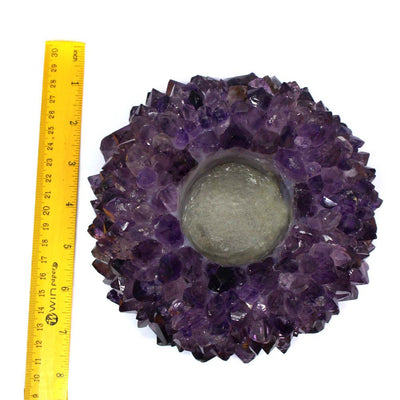 large amethyst point candle holder next to a ruler for size reference