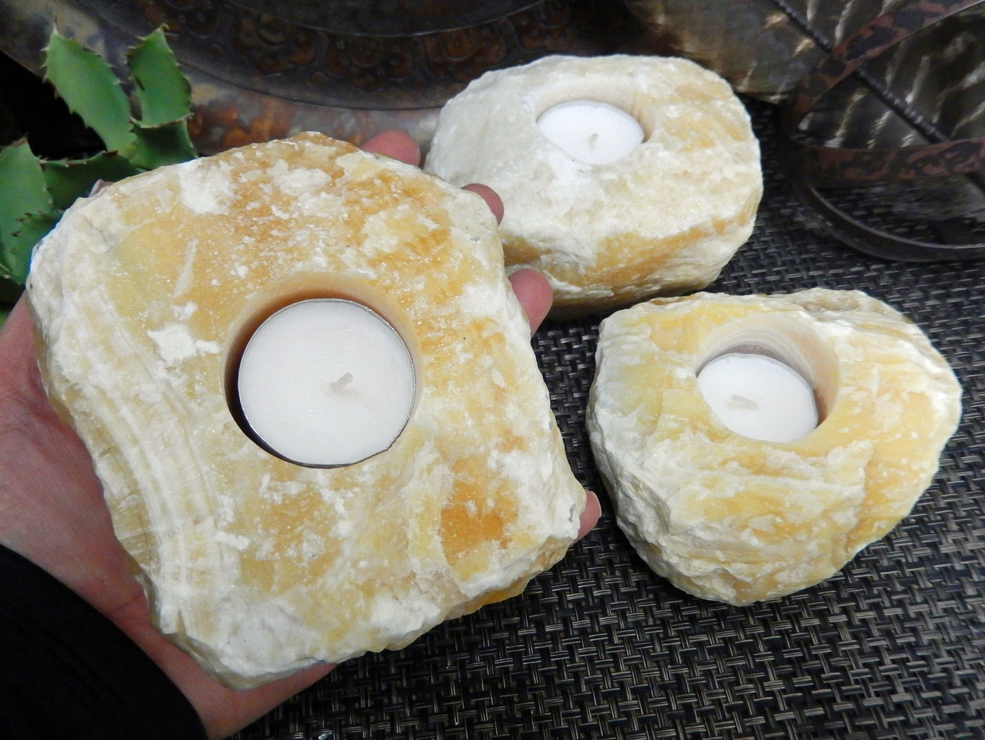Mexican Orange Calcite Candle Holders with one in a hand for size reference