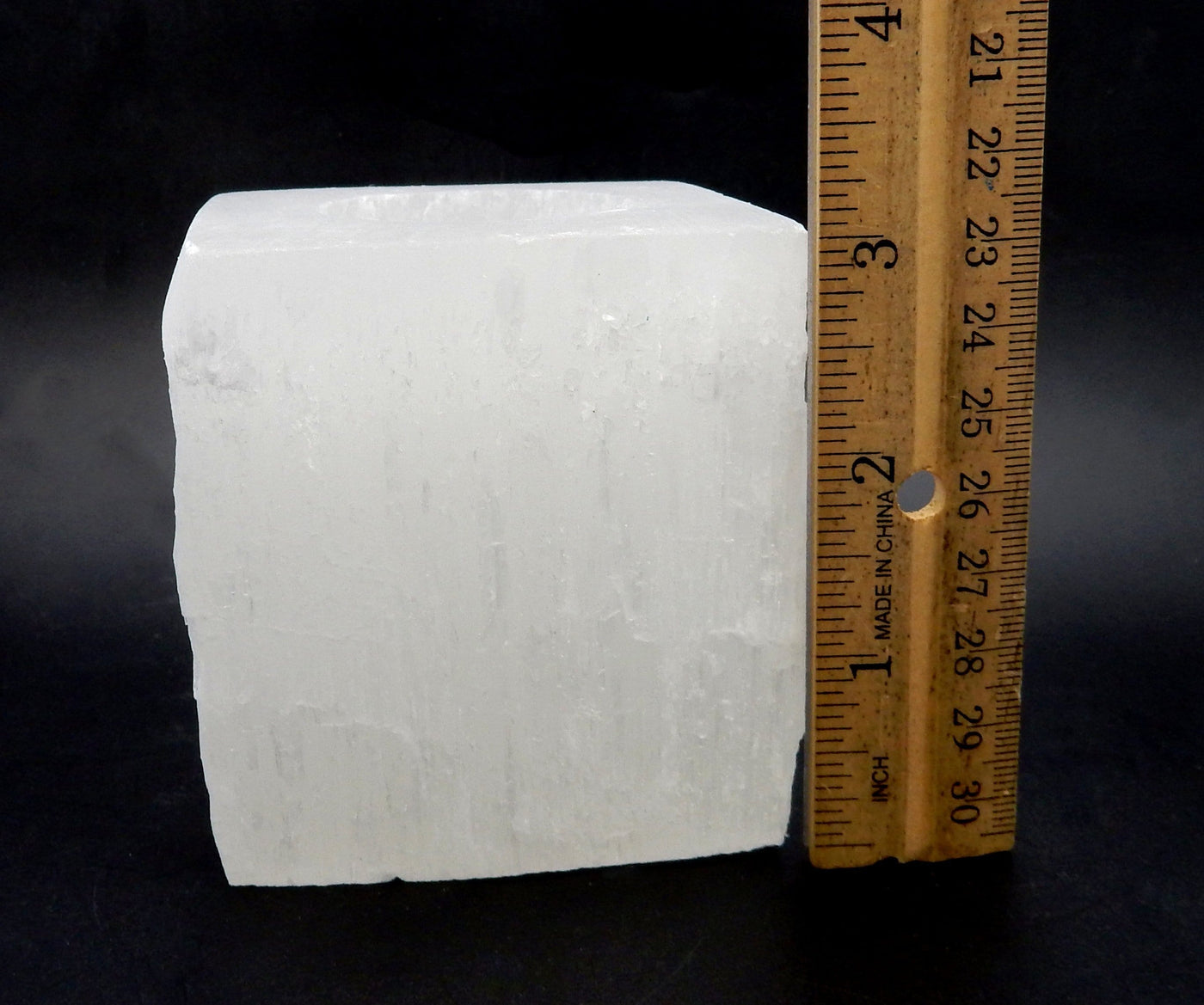 Single Square Shaped Selenite Candle Holder next to a ruler for size comparison 