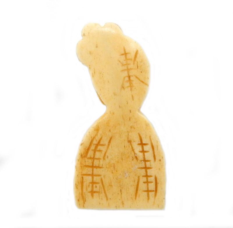 backside of a bone carved woman on a white background