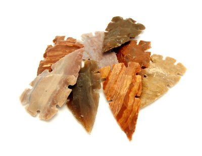 8 jasper arrowheads stacked on top of each other on a white background