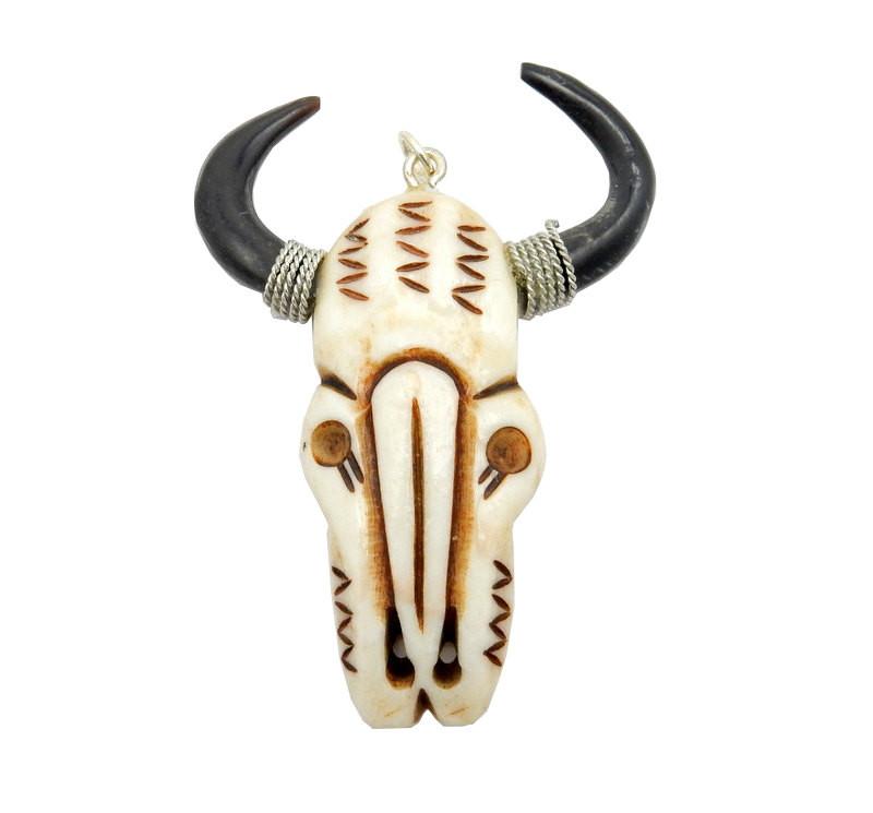 close up of one bone carved cattle head on a white background