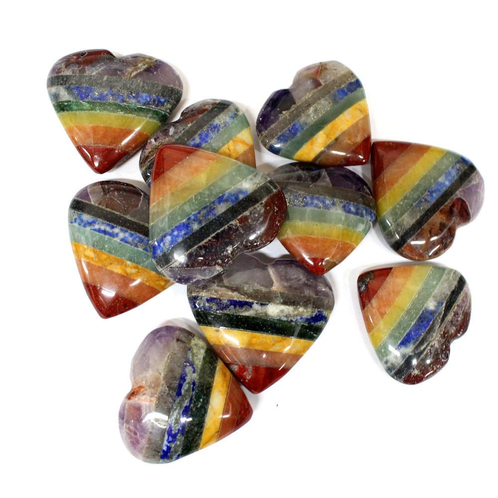 many seven chakra stone hearts in a pile