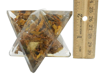 Large Orgone Merkaba Star on a white surface, next to ruler for size reference.