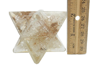 Large Orgone Merkaba Star on a white surface, next to ruler for size reference.
