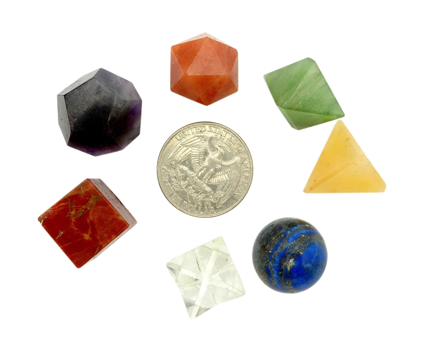 Seven chakra sacred stone geometry on a white background.  Pictured with a quarter to show stones are about quarter size.