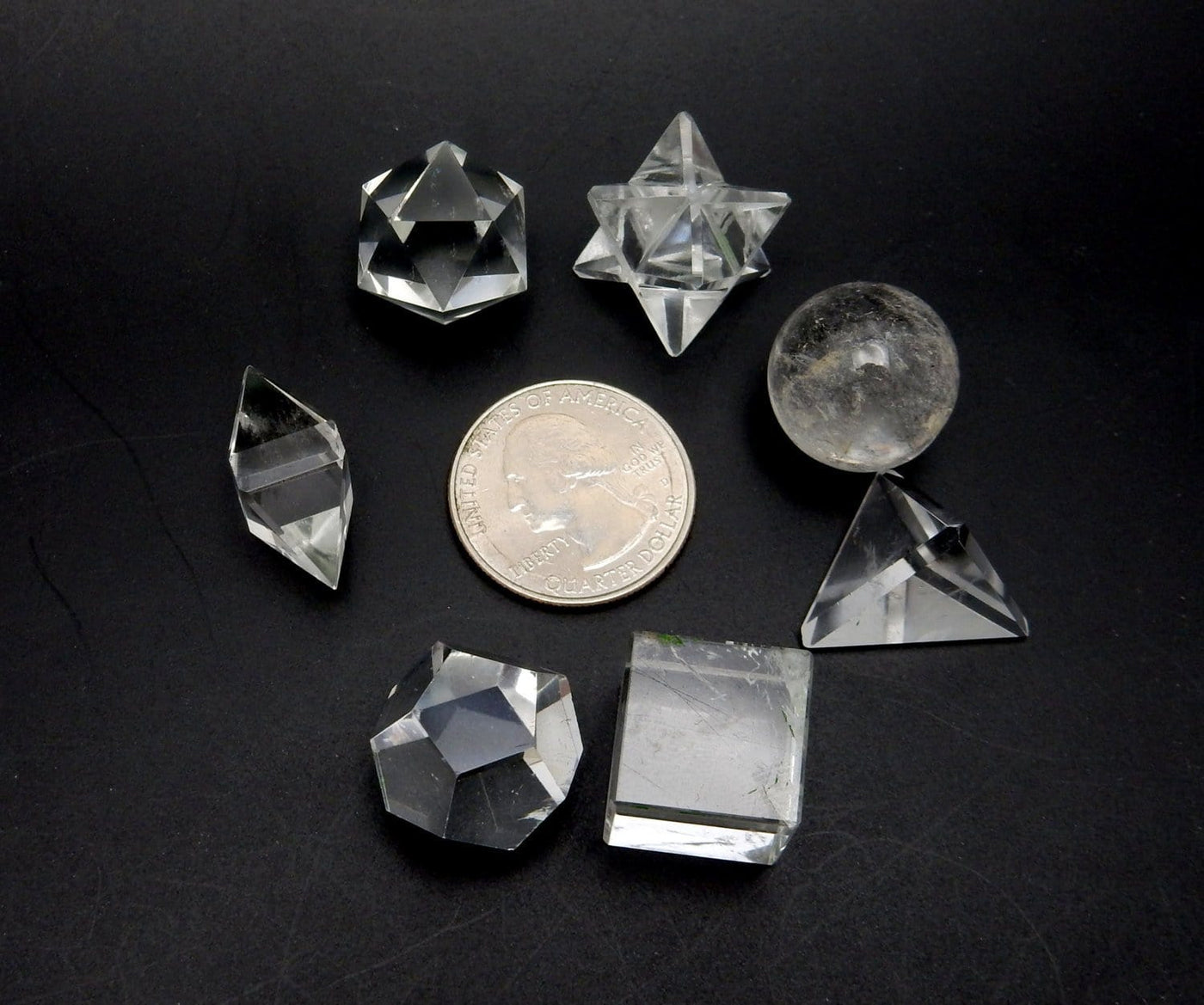 Crystal Quartz Geometric Shape next to quarter for size reference