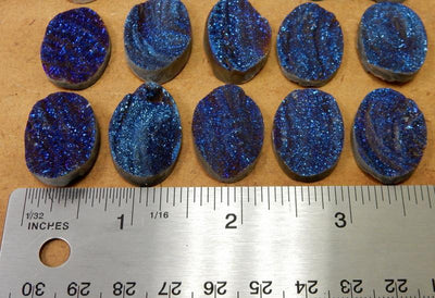 Mystic Blue Titanium Chalcedony Druzy Oval Cabochons next to a ruler for size