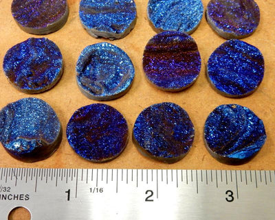8 Titatium Druzy Round Cabachons next to a ruler for size reference
