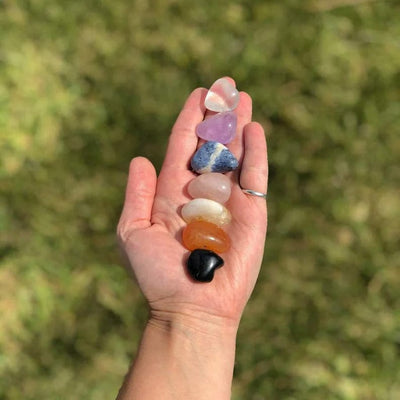 Chakra and Selenite Charging Set--front shot view of stones showing size comparison and detail on hand.