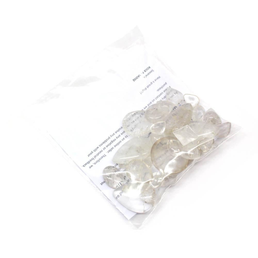 1/4 lb bag of Mixed Shapes Clear Crystal Cabochons displayed in plastics bag