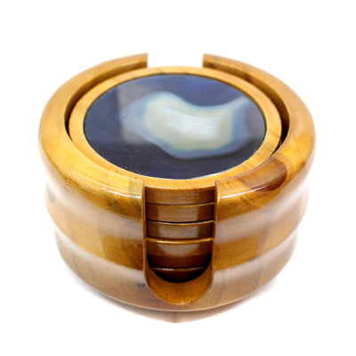 Side view of agate coasters in wooden holder.