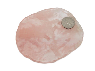 rose quartz coaster with a quarter on top for size reference