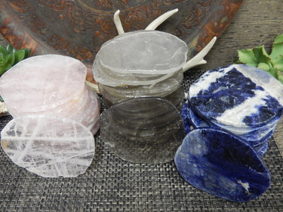 Coasters displayed to show they come in sodalite smoky quartz and rose quartz