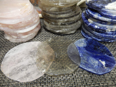Free Form Stone Coaster Picture Of All Three Coasters With Background Of Three Stacks Of Smokey Quarts. Rose Quartz And Sodalite.