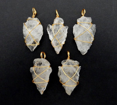 multiple crystal quartz arrowheads displayed to show the slight differences in the sizes 