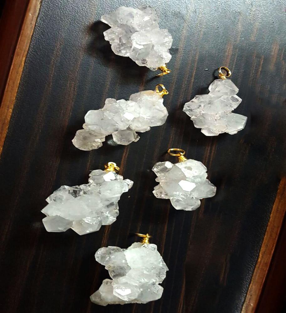 6 crystal cluster pendants on a table