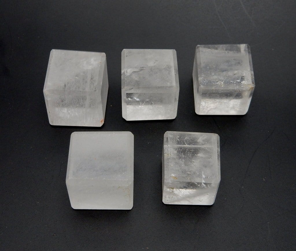 5 crystal cubes on a table