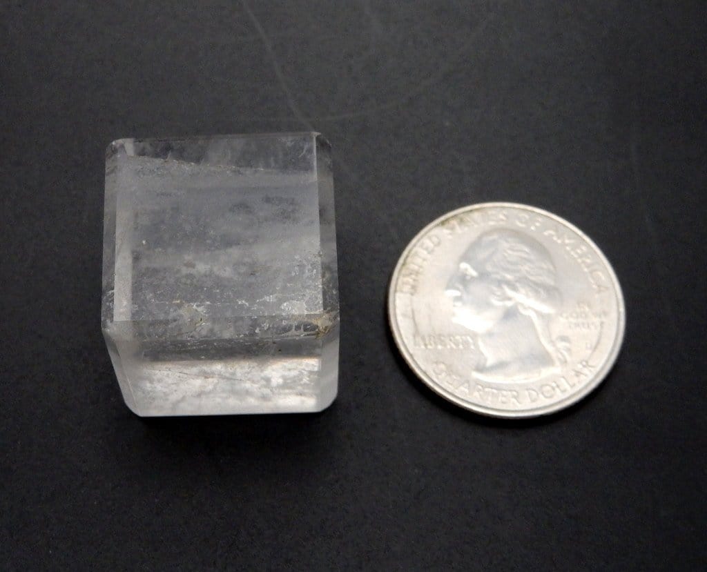 crystal cube next to a quarter