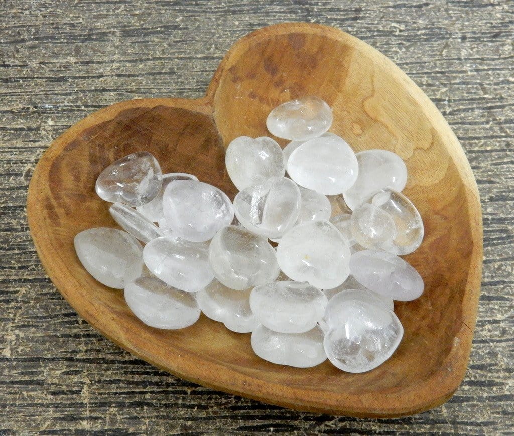 crystal quartz heart with decorations in the background