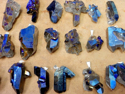 mystic blue crystal cluster pendants displayed to show the differences in the sizes 