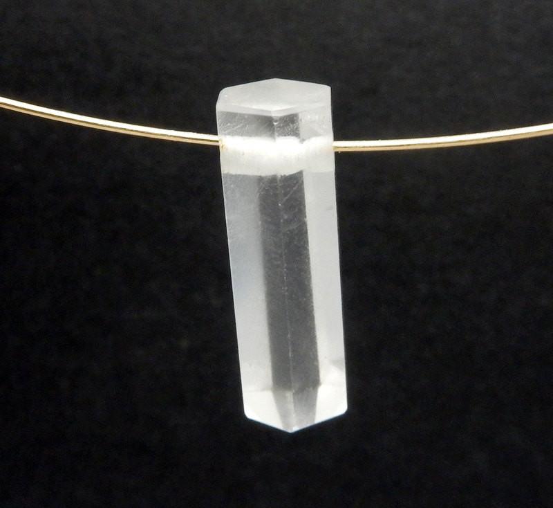 Crystal Quartz Pencil Point Bead  up close to show a gold wire through the drilled hole