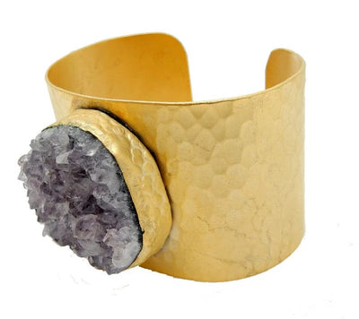 Side view of Amethyst Cuff with thick gold plated band and amethyst cluster in the center.