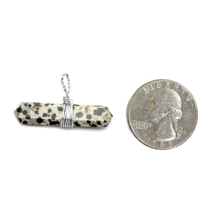Silver Tone Wire Wrapped Dalmatian Jasper Double Point Pendant Next to a Quarter on White Background.