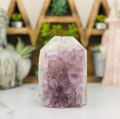 Amethyst Druzy Polished Tower Point with decorations blurred in the background