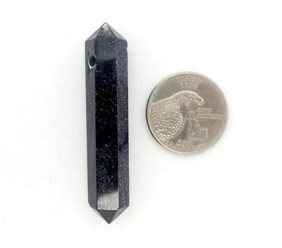 purple goldstone point bead next to a quarter for size reference